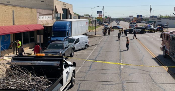 VIDEO: During a medical emergency, a trucker plows into parked vehicles and almost hits a barbershop.