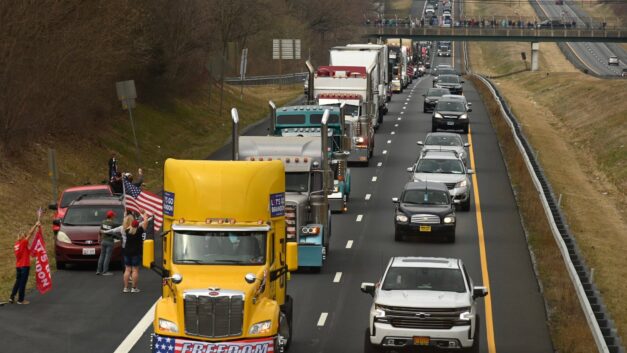 Hundreds of vehicles protesting Covid mandates surround Washington, led by truckers.
