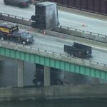 A UPS truck crashed off of a bridge in Indiana. The driver was hanging off the bridge support!