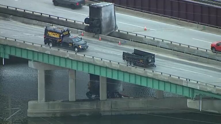 A UPS truck crashed off of a bridge in Indiana. The driver was hanging off the bridge support!